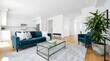 © wakhid saiful anam - Modern open concept living room interior with a teal velvet sofa, glass coffee table, and a large indoor plant in a bright, minimalist home design