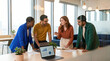 © ADDICTIVE STOCK - Business team discusses project progress in modern office