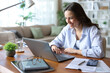 © Antonioguillem - Happy teleworker working on oline with a laptop at home