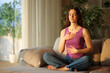 © Antonioguillem - Teenage girl doing breathing exercises at sunset at home