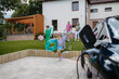 © Halfpoint - Happy family leaving home for summer vacation with luggage and pool toys.