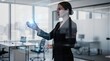 © AGI Studio - A professional woman interacts with a futuristic transparent digital interface, analyzing data and charts in a modern office environment.