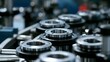 © Bussakon - A detailed view of a heavy industrial assembly line where metallic parts are actively moving with glinting reflections and strong shadows