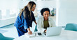 © Julia - Two women guide one another at laptop