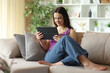 © PheelingsMedia - Satisfied teenage girl watching media on tablet at home