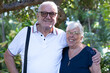 © luciano - Senior couple sharing a joyful embrace outdoors, smiling together, representing lasting love, healthy aging, retirement lifestyle, happiness, and a strong relationship in nature