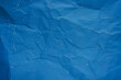 © tuan12 - Distressed blue paper texture background with crumpled surface and white scratches