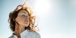© Fun Factory - Sensual young woman, long, wavy red hair, natural freckles, white shirt, closed eyes peacefully relaxing, enjoying the wind, bright warm glow of the pure summer sun freedom outdoors,  copyspace