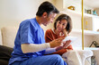 © Cristina Garcia - Caregiver explaining health information to senior woman with big smile