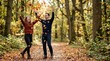 © Xenia - Playful couple throwing autumn leaves in a forest. Happy man and woman walking on a woodland path during fall season. Outdoor recreation and romantic relationship concept
