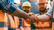 © Rostyslav - Close-up handshake between construction workers with safety gear outdoor