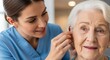 © Resfa - Woman audiologist fitting a hearing aid for an elderly woman. Professional medical care for senior patient. Hearing loss treatment and healthcare consultation in a clinic setting.