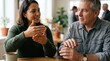 © Tgad - Two people engaged in a conversation, using hand gestures to communicate ideas