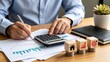 © Lucas - Businessman analyzing financial charts and calculating budget with calculator, accounting concept, investment planning, corporate finance management, economic growth strategy