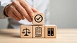 © Mia - Hand placing a checkmark block on top of legal and audit symbols, representing compliance, quality assurance, regulatory approval, business ethics, financial auditing