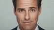 © PURE SP - Portrait of a confident businessman wearing a suit with a neutral expression against a soft background