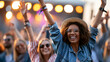 © Nataliya - Anonymous group of diverse young people smiling and raising their arms at an outdoor music festival with stage lights visible, faceless, defocused, with copy space