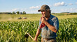 © Sadek - Weathered Farmer Wiping Sweat from Brow During Hard Day of Work in Green Corn Field Under Blue Summer Sky