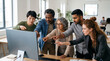 © Daniyal - Diverse coworkers gathered around a large blank computer monitor, pointing and discussing ideas during a focused collaborative work session in a bright contemporary office