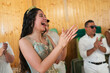 © Gonzalo Infiesta - Happy quinceanera applauding during traditional family celebration