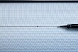 © Fotograf - A pen sits on top of a piece of paper, ready to write