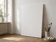 © Chatpong - Blank canvas in bright artist studio with brushes and natural light