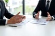 © 企 陈 - Two businessmen discussing documents at table