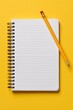 © Arfa_Media - Notebook with yellow pencil on a bright blank spiral stationery office background