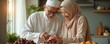 © Viktor - Elderly Muslim couple smiles preparing dates in home kitchen. Man wears kufi cap, woman wears hijab. Family cooks together preparing food for Ramadan celebration or Eid meal.