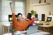© Stella 16 - Young woman business colleagues or employee do exercise at work in office or taking a break. Relaxing and stretching hands after long hours of work. Stress relief in workplace