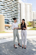 © milanmarkovic78 - Business Professionals Share Ideas While Collaborating Outside in an Urban Office Environment During a Sunny Day