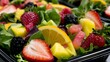 © Bussakon - A visually appealing arrangement of fresh boxed salad ingredients featuring vibrant red fruit slices and crisp vegetables