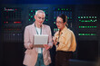 © Zamrznuti tonovi - Two women engineers standing in a server room, discussing data operations and advanced technology for it management