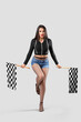 © Pixel-Shot - Beautiful young woman with racing flags on grey background