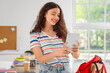 © Pixel-Shot - Female student with tablet computer in kitchen
