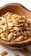 © Cantik - Roasted Pumpkin Seeds in a Wooden Bowl.
