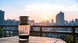 © MSahlul - Traditional Vietnamese drip coffee on a wooden balcony table with a scenic city sunrise view