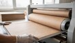 © DigitalSpace - Foam boards being laminated with natural kraft paper showcasing the ecofriendly surface bonding technique in a clean workshop environment.