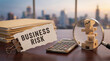 © Emre Akkoyun - Business risk evaluation and management concept with fragile wooden blocks, magnifying glass, calculator