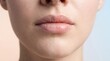 © Thipsuda - Smooth lip texture hydrated skin natural makeup close up of female lips healthy complexion soft lighting beauty care gentle expression skincare pastel background