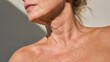 © sknab - Close-up of mature woman neck and shoulder skin texture with natural wrinkles and light shadows