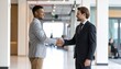 © Aimi - Two smiling business professionals shaking hands in a successful agreement