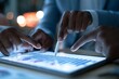 © TAlex - Hands using stylus and finger to analyze bar chart on digital tablet