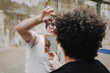 © Luciano Spinelli/Stocksy - POV Focused barber Haircut With Hand Mirror