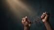 © EsterDyah - Hands breaking old iron chain apart under light beam in a  remembrance slave trade concept