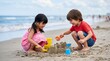 © Ally_art - Asian little girl and Caucasian boy digging in sand at beach. Happy children building sandcastle with shovel and bucket. Summer vacation, childhood activity and leisure concept.