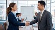© Joshuva stock - Professional business handshake between a man and woman in a modern office boardroom with handshake business colleagues partnership
