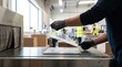 © Stitch - Factory worker placing a vinyl record sleeve into a shrink wrap packaging machine