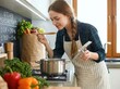 © Faris - Woman happily cooking fresh ingredients in a modern kitchen, savoring the delicious aroma of her meal preparation