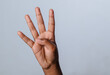 © StanleyRevaldo - Human hand forming a number four gesture using fingers, isolated on white background